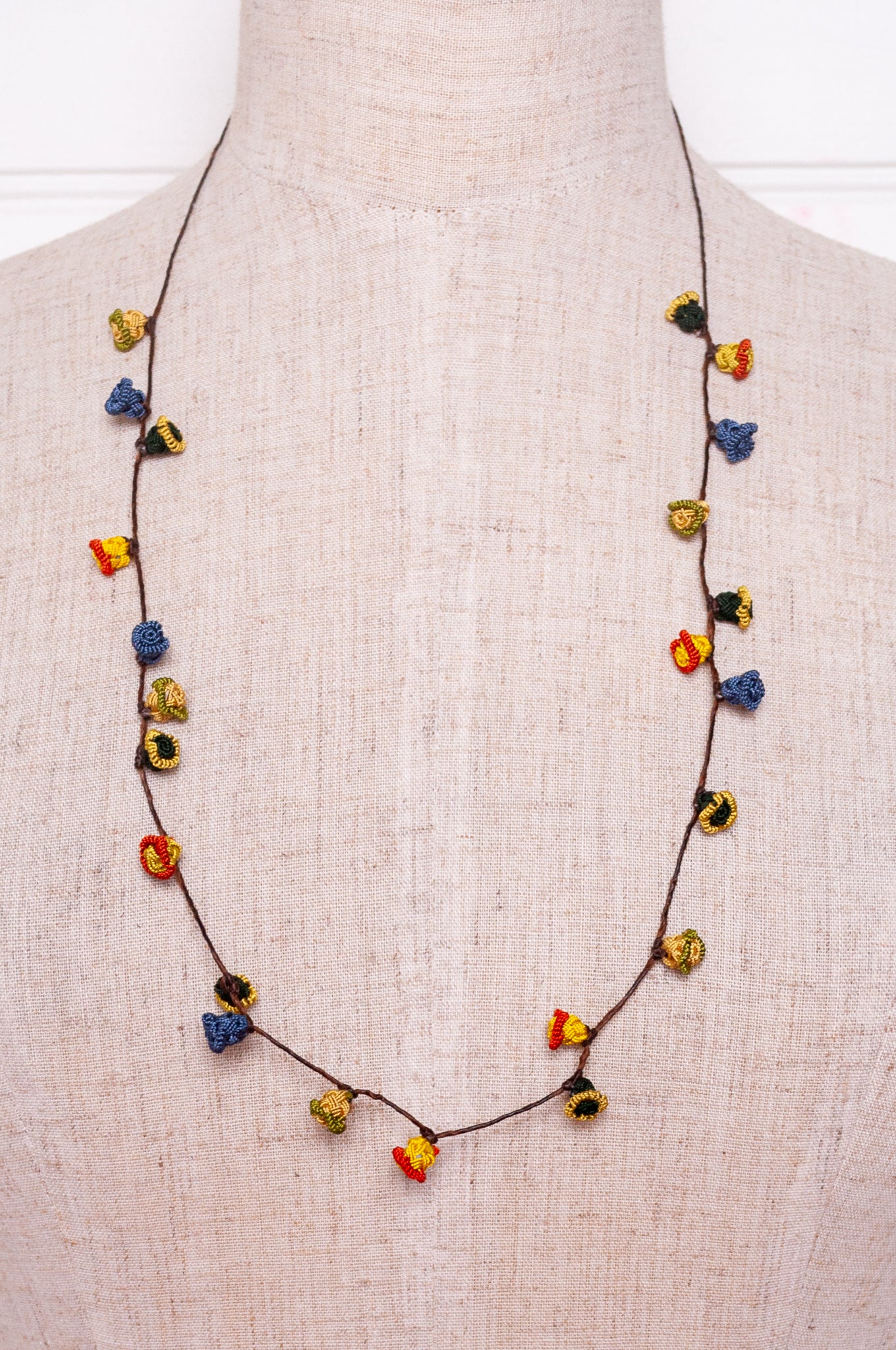 Handmade Moroccan button necklace in  blue, olive, mustard and pink.
