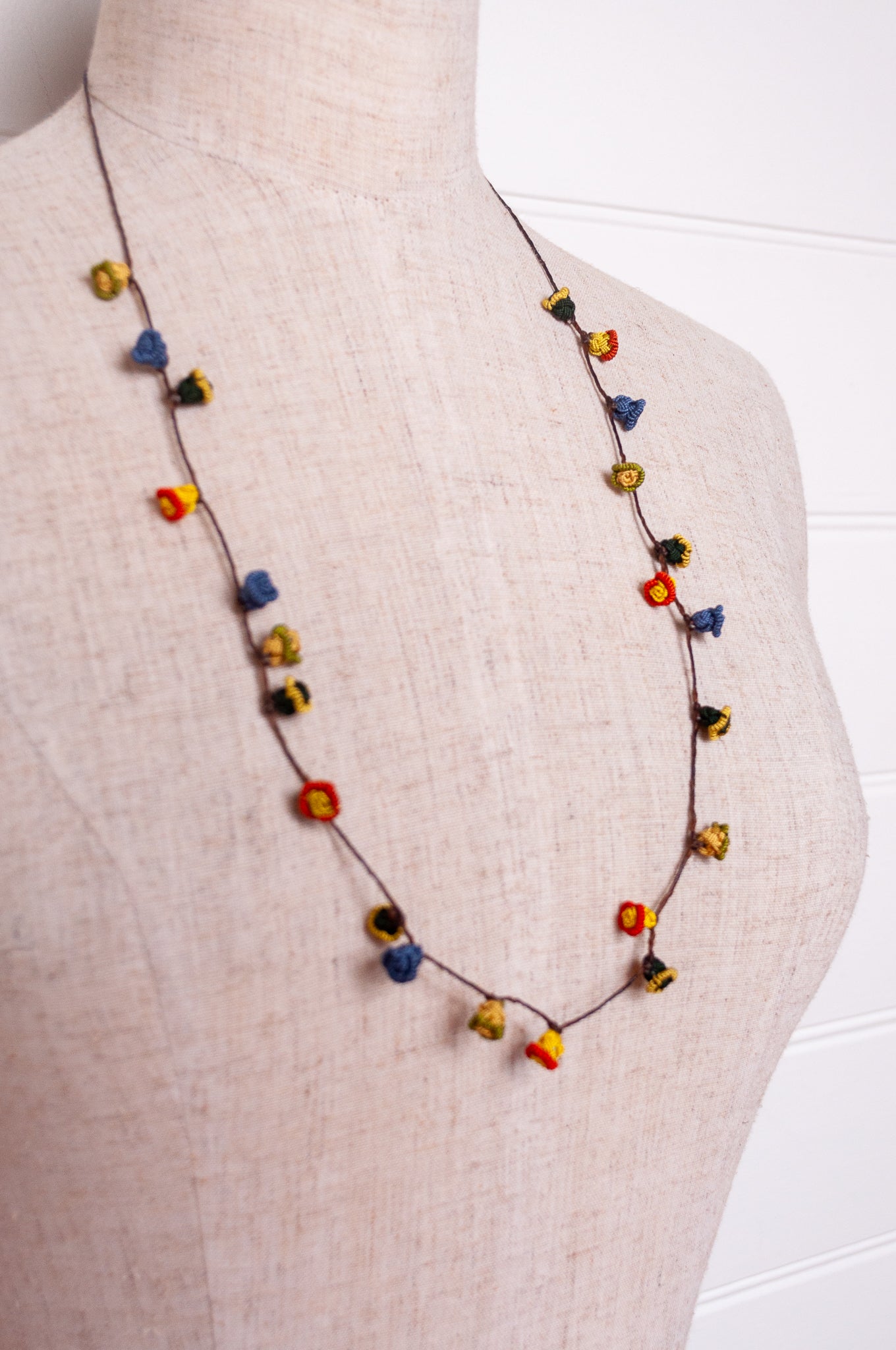 Handmade Moroccan button necklace in  blue, olive, mustard and pink.