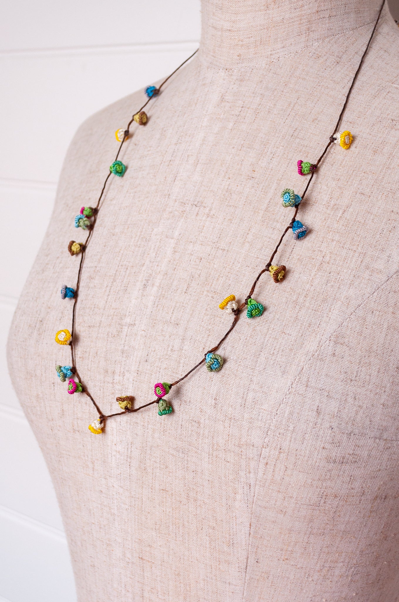 Handmade Moroccan button necklace in  soft pastels.