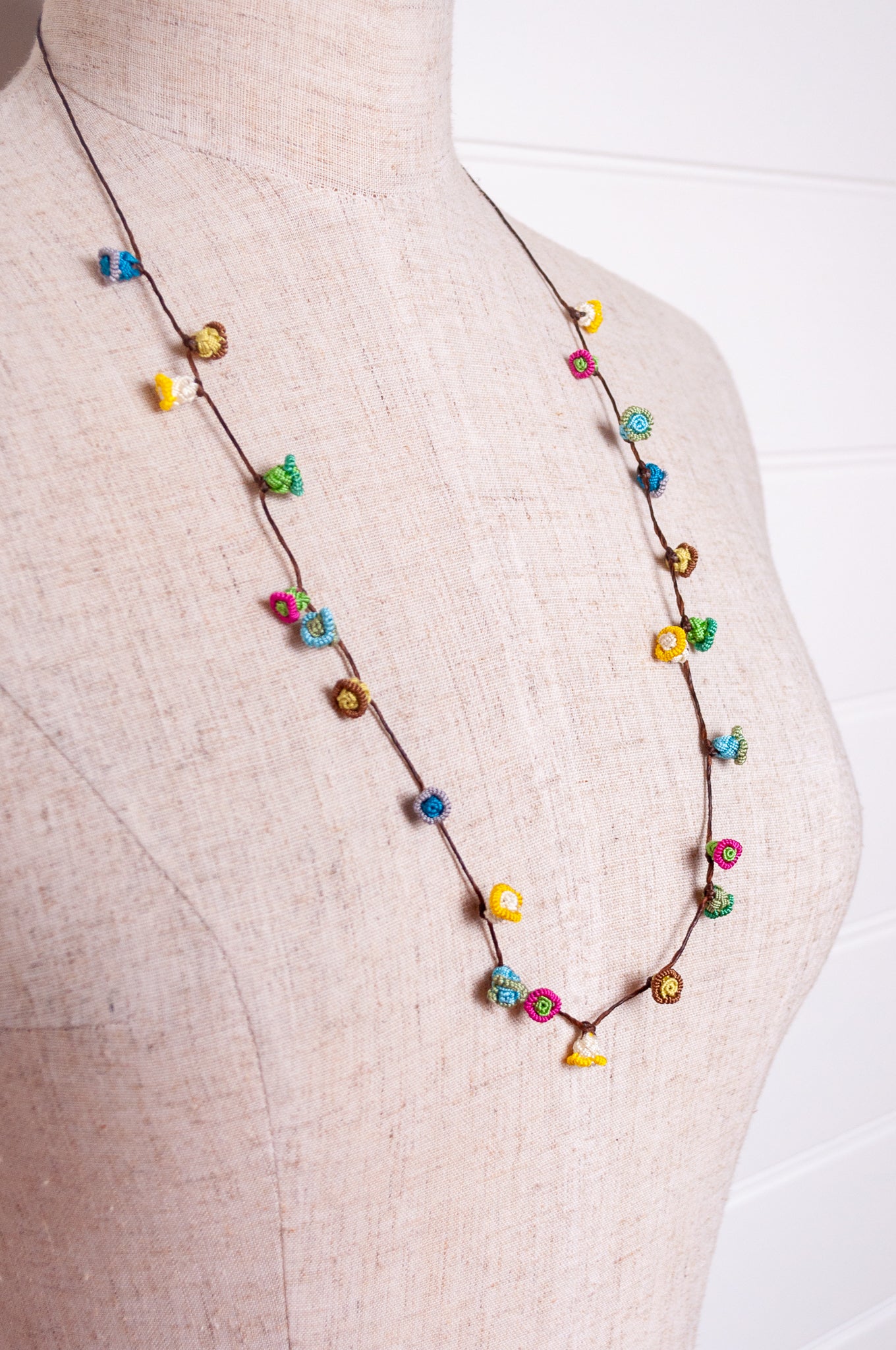 Handmade Moroccan button necklace in  soft pastels.