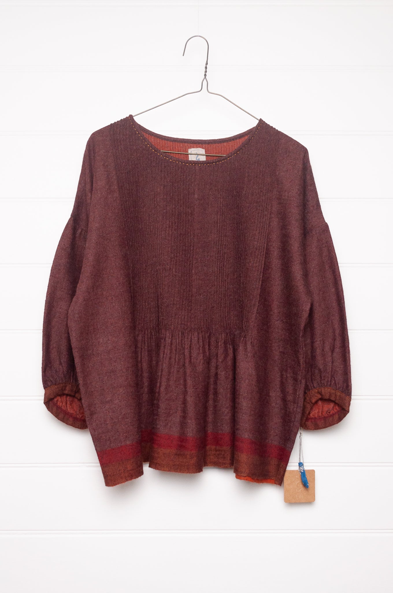 Dve Anisha pintucked top in madder red wool.