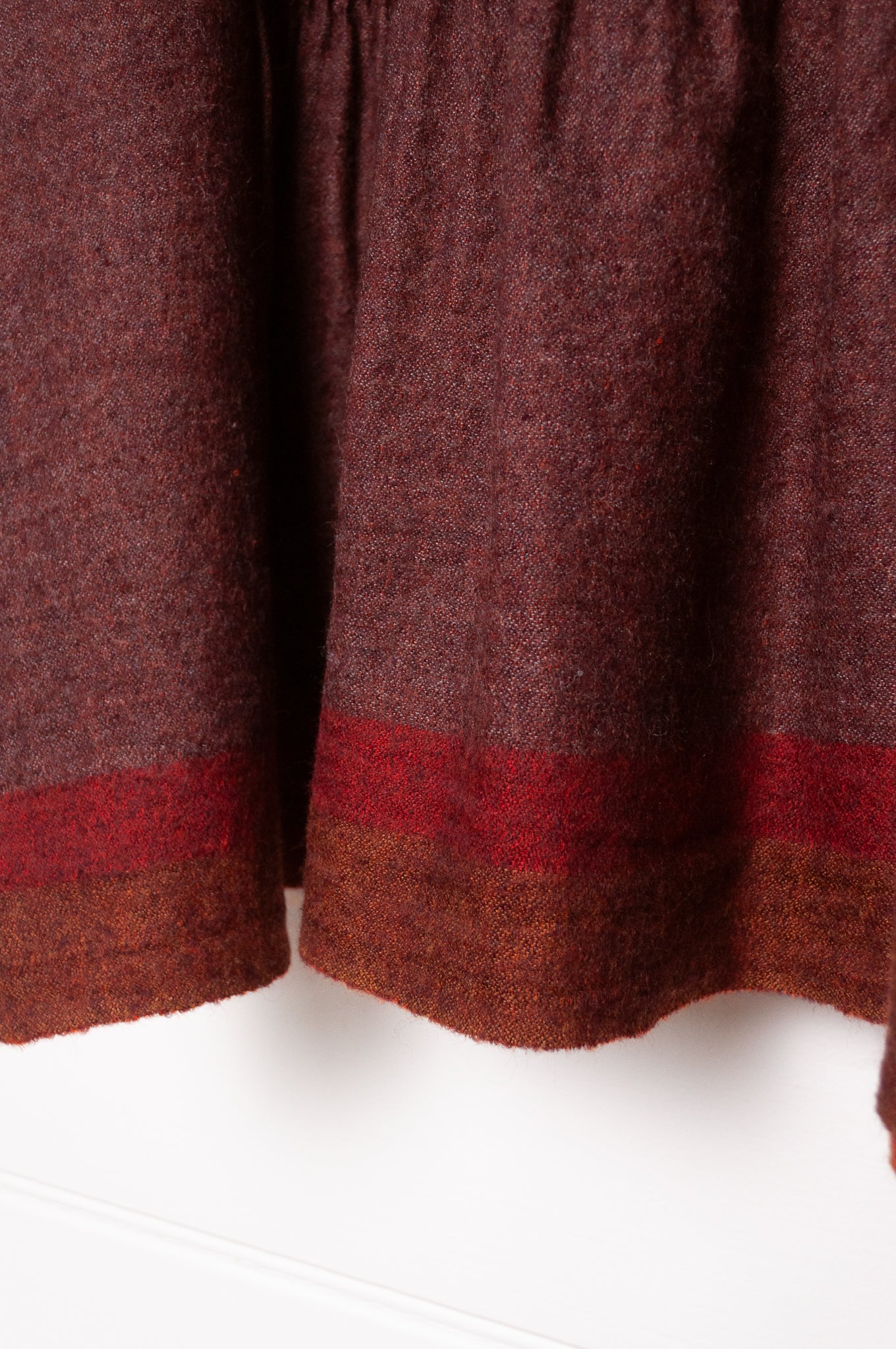 Dve Anisha pintucked top in madder red wool.