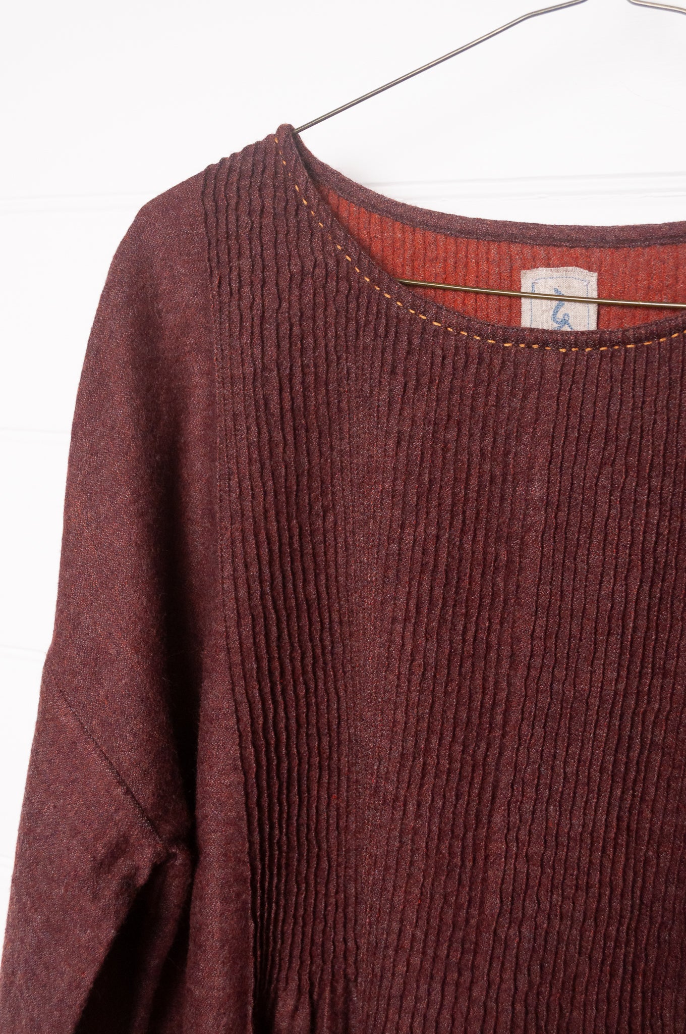 Dve Anisha pintucked top in madder red wool.