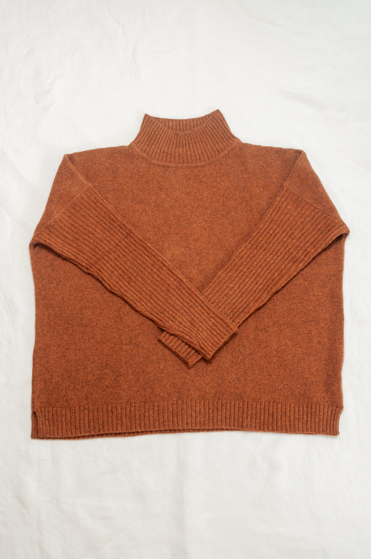 Baby yak wool Maxim one size turtle neck sweater with rib sleeves in rust brown.