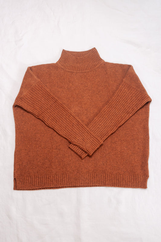 Baby yak wool Maxim one size turtle neck sweater with rib sleeves in rust brown.