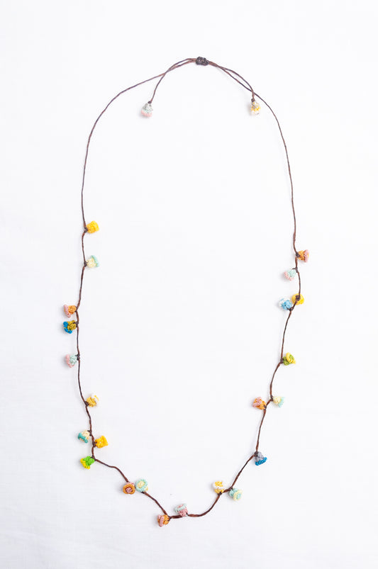 Handmade Moroccan button necklace in sky blue, soft yellow, rose pink and latte.