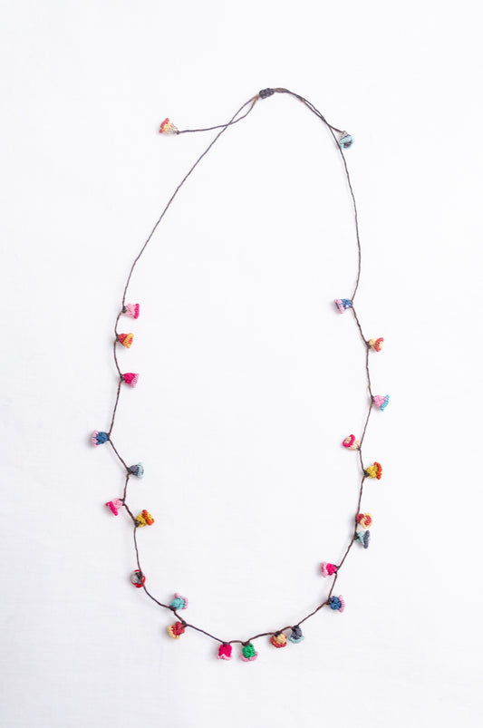 Handmade Moroccan button necklace in broght pastels blue, lemon yellow, rose pink.