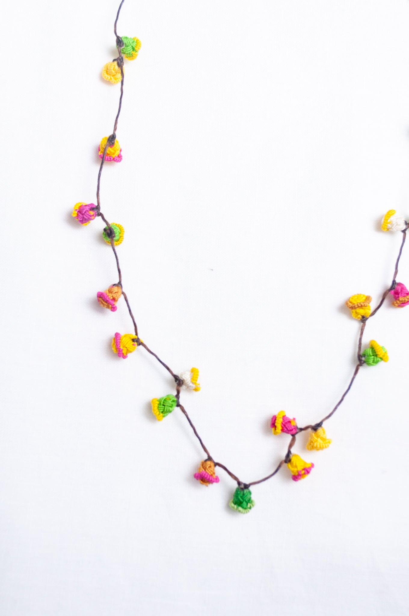 Handmade Moroccan button necklace in bright lemon yellow, rose pink and leaf green.