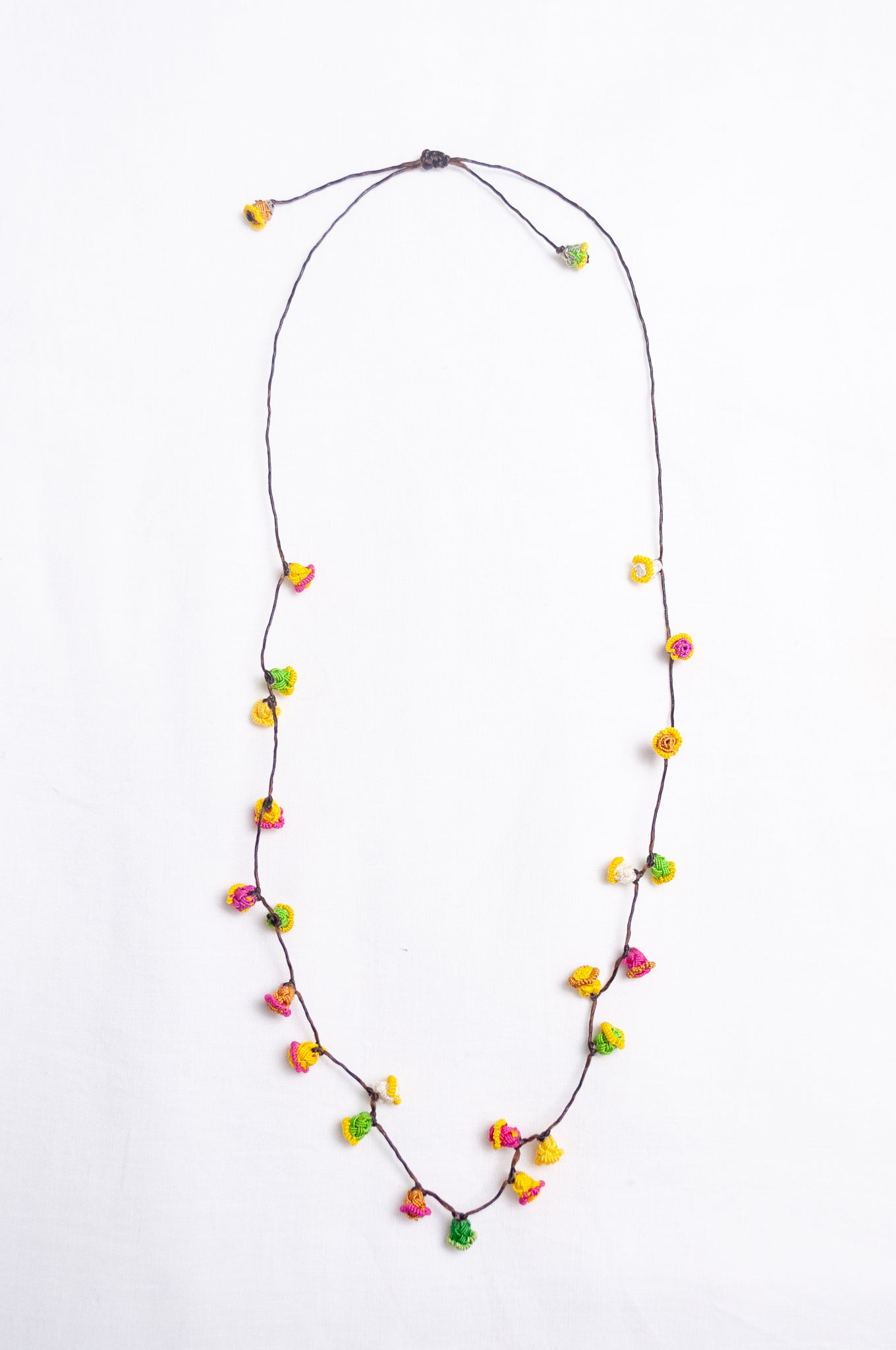 Handmade Moroccan button necklace in bright lemon yellow, rose pink and leaf green.