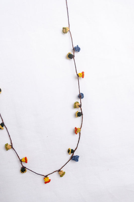 Handmade Moroccan button necklace in  blue, olive, mustard and pink.