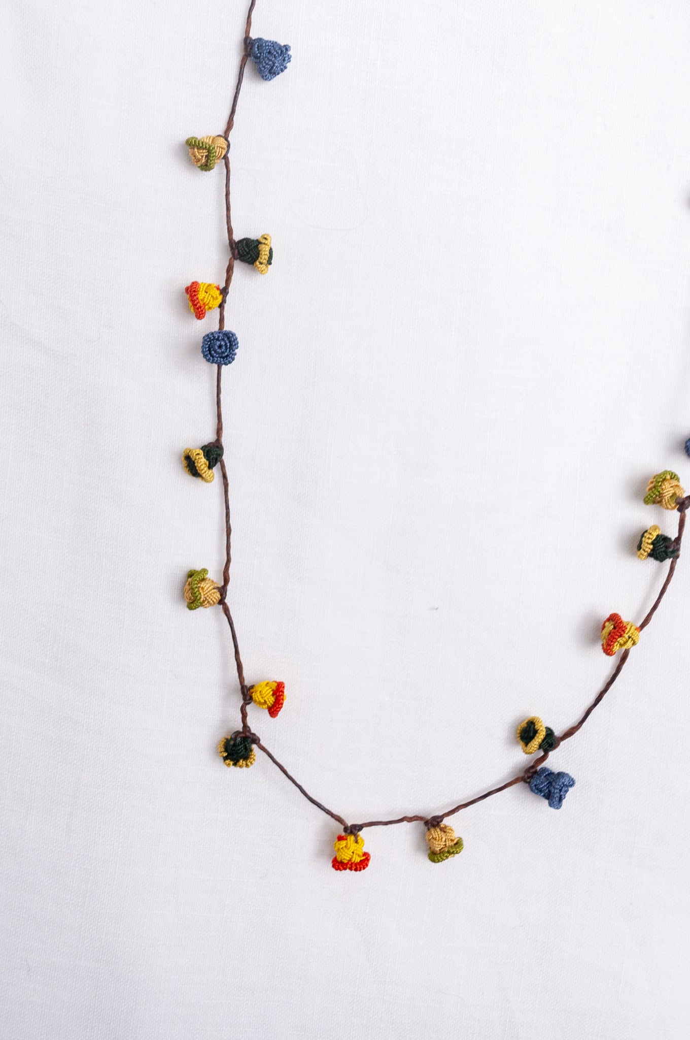 Handmade Moroccan button necklace in  blue, olive, mustard and pink.