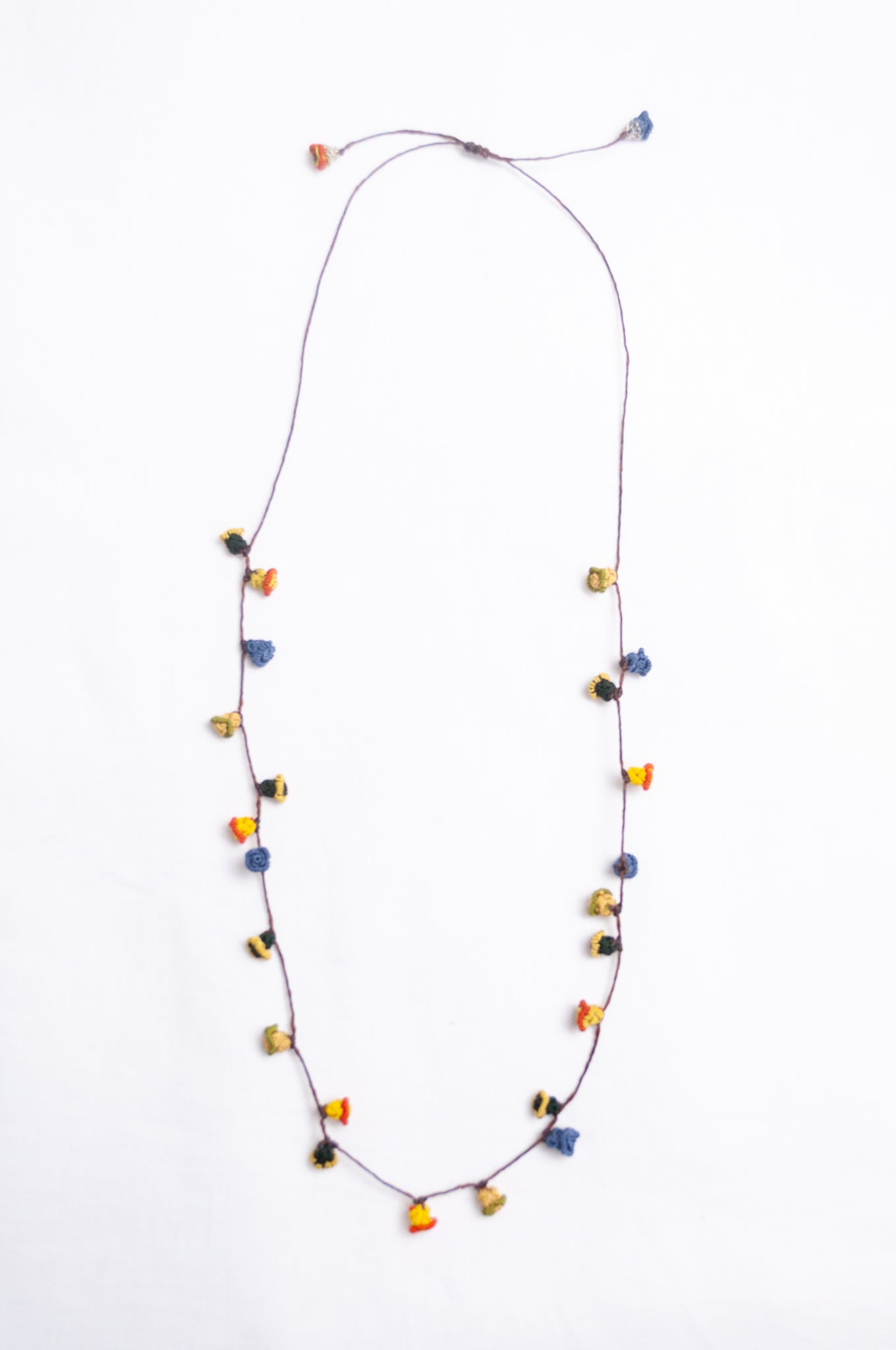 Handmade Moroccan button necklace in  blue, olive, mustard and pink.