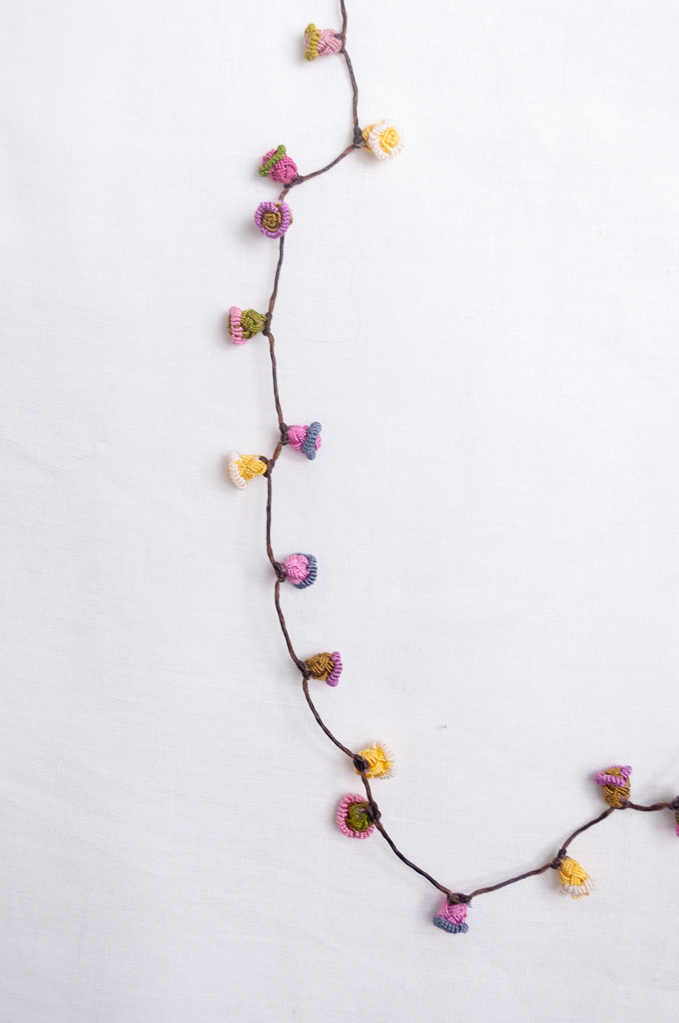 Handmade Moroccan button necklace in  soft pink, lemon and olive.
