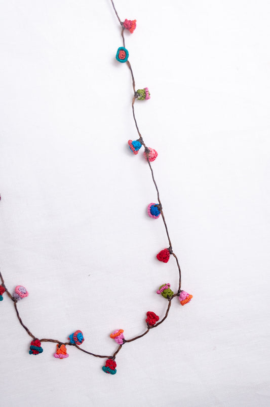 Handmade Moroccan button necklace in  turquoise, pink and red.