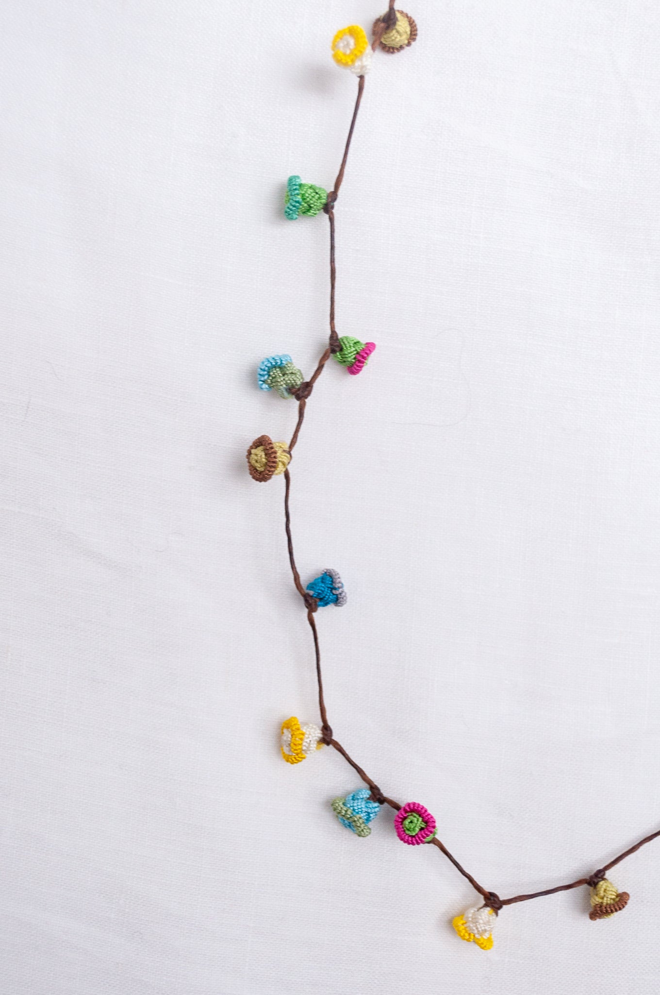 Handmade Moroccan button necklace in  soft pastels.