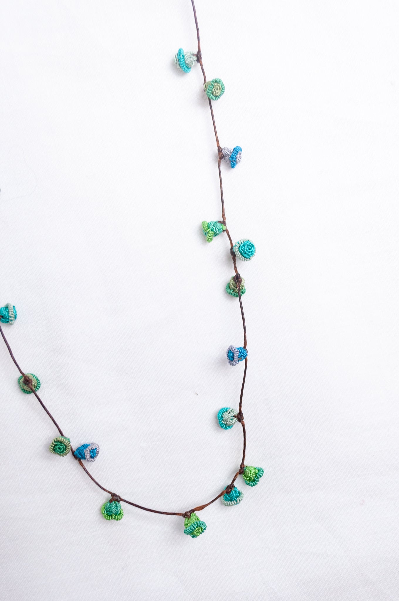Handmade Moroccan button necklace in  blues and greens.