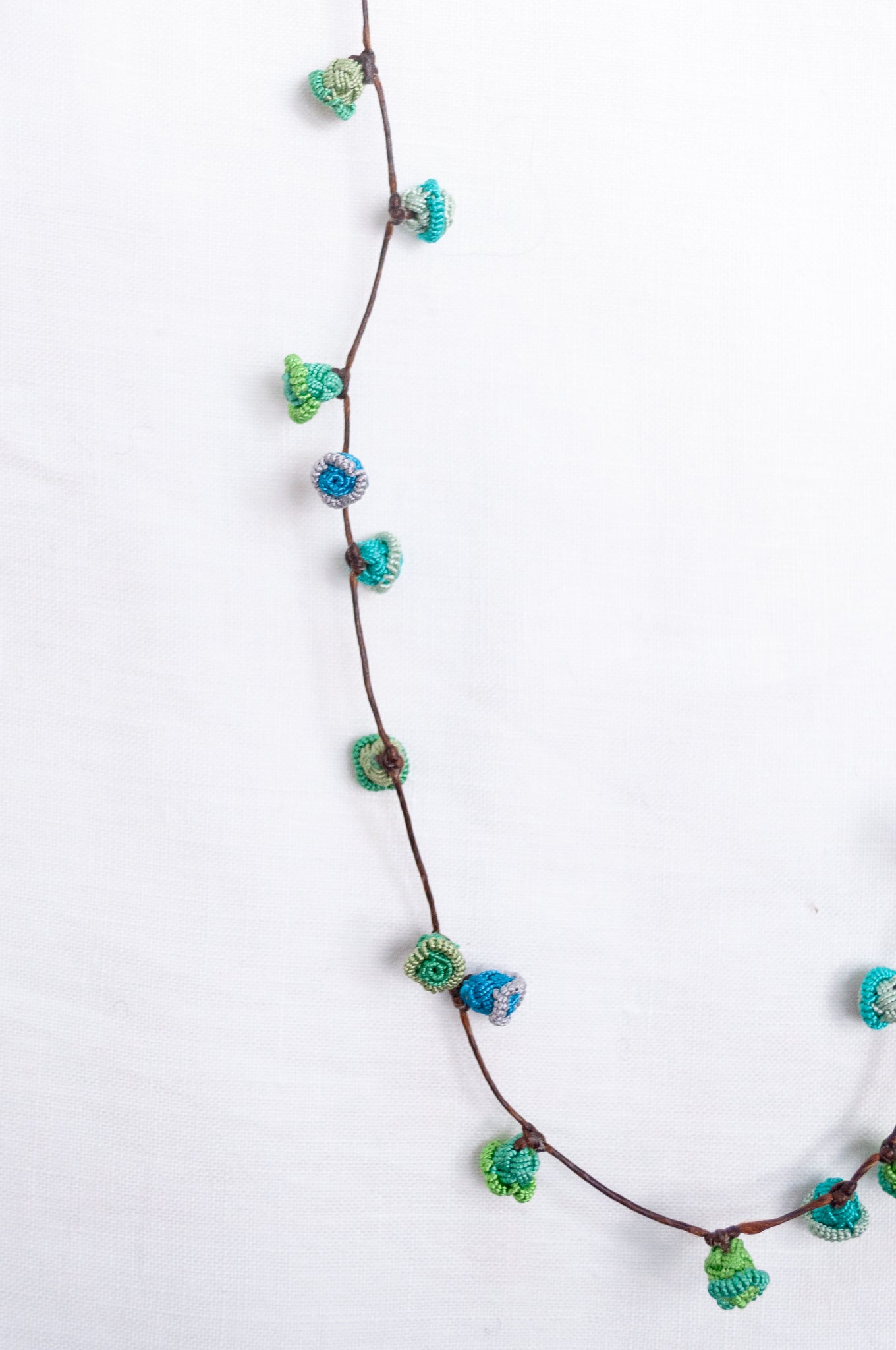 Handmade Moroccan button necklace in  blues and greens.