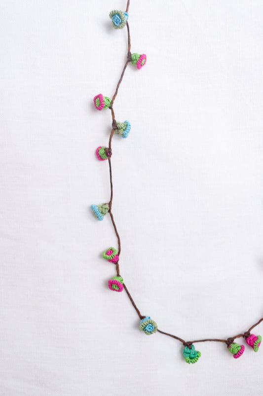 Handmade Moroccan button necklace in  blue, pink and soft green.