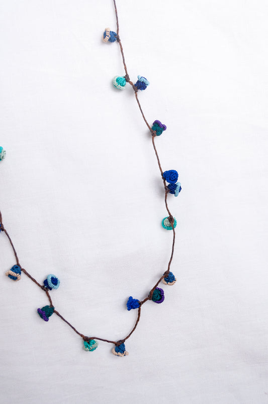 Handmade Moroccan button necklace in  ocean blues and greens.