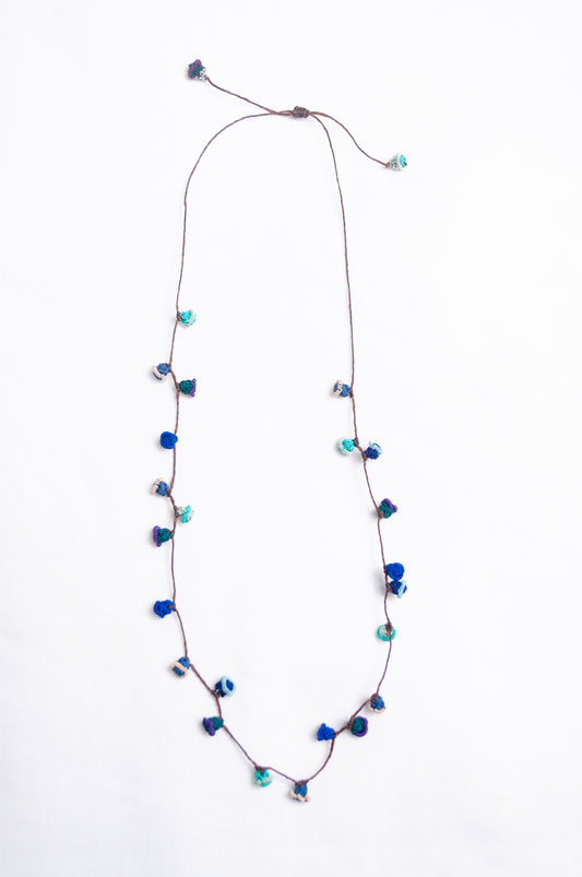 Handmade Moroccan button necklace in  ocean blues and greens.