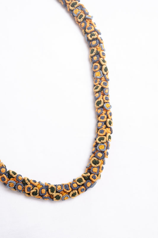Moroccan flower button Oznati necklace in mustard yellow, latte and grey.
