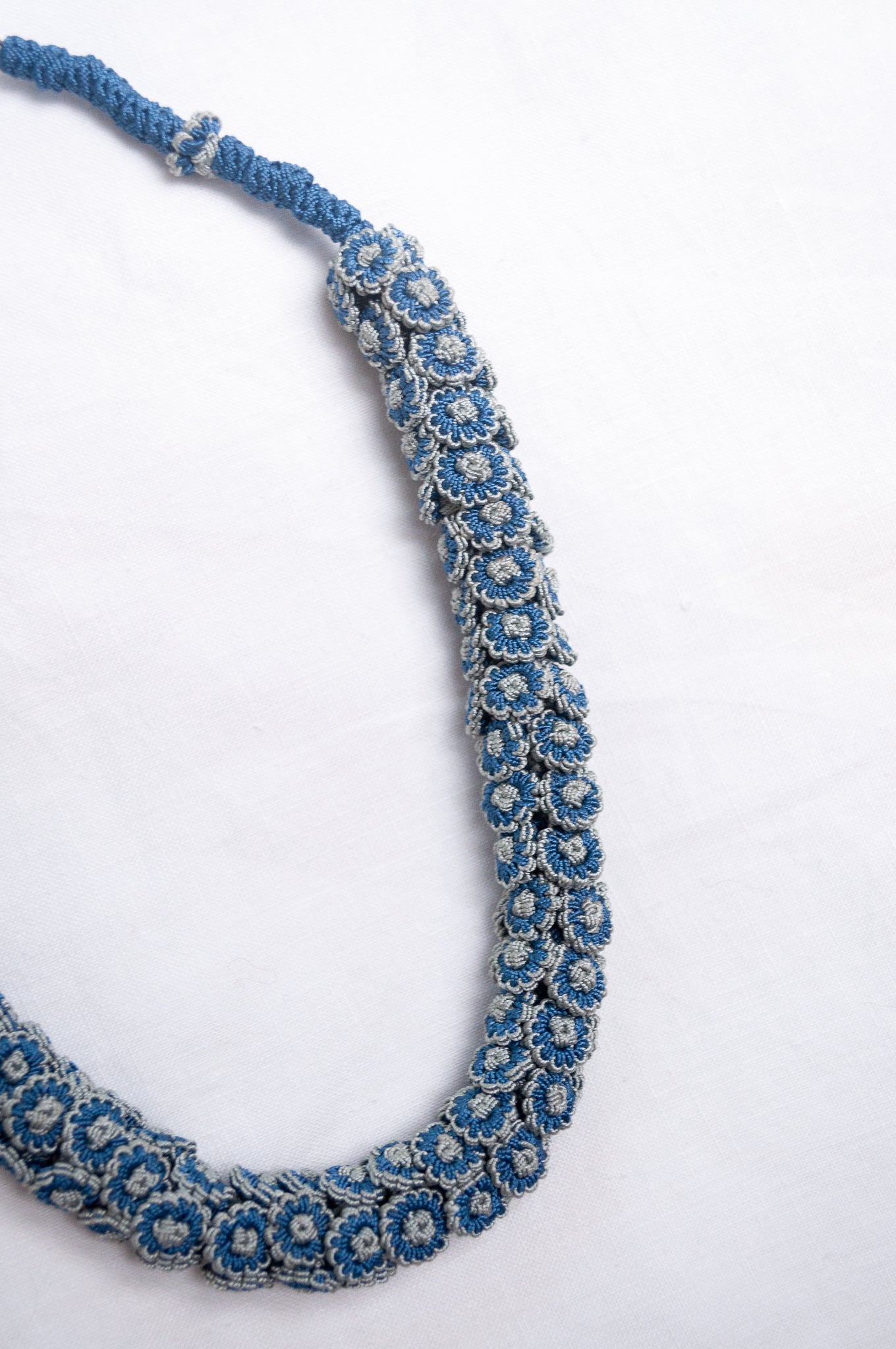 Moroccan button Latifa necklace in denim blue and silver grey button flowers.