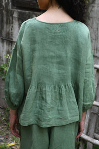 DVE Anisha one size pin tucked top in basil green linen.