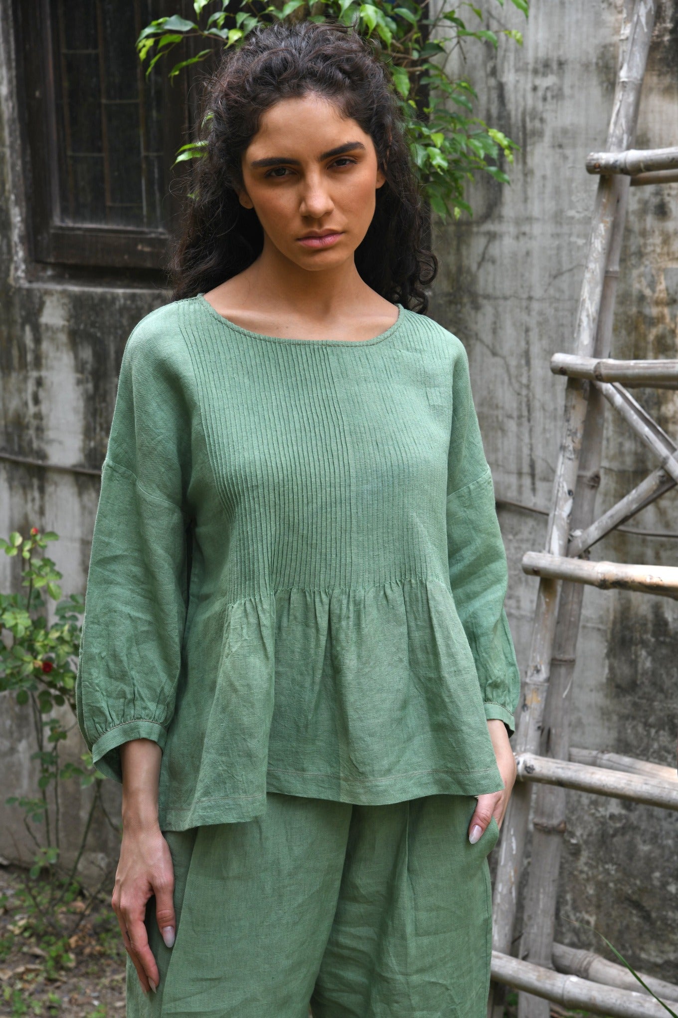 DVE Anisha one size pin tucked top in basil green linen.
