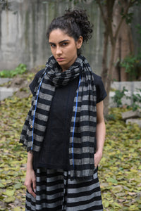 DVE linen gauze scarf in charcoal and black stripe with blue selvedge edging.