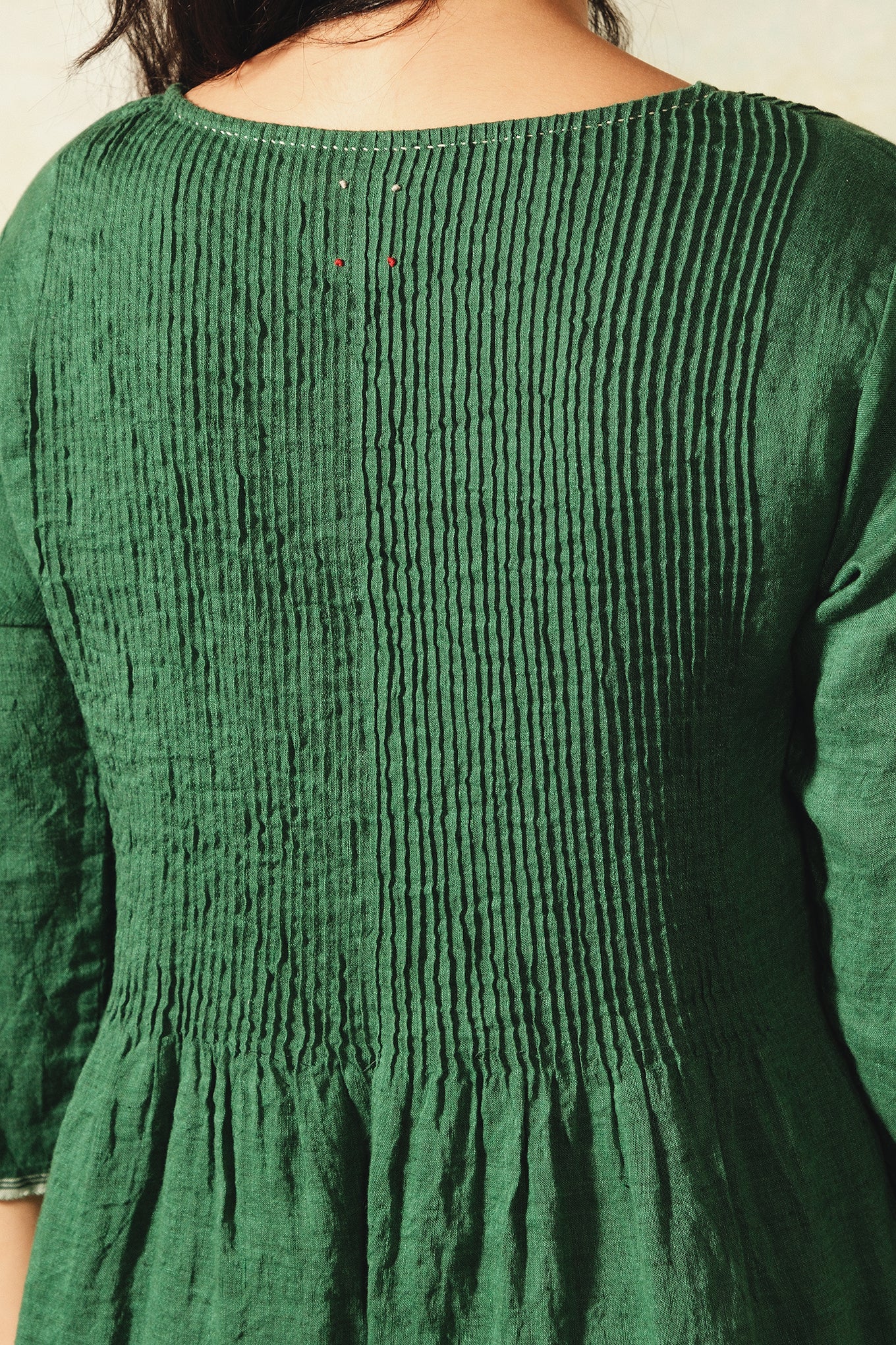 Dve emerald green linen Raka dress pintucked bodice, selvedge details.
