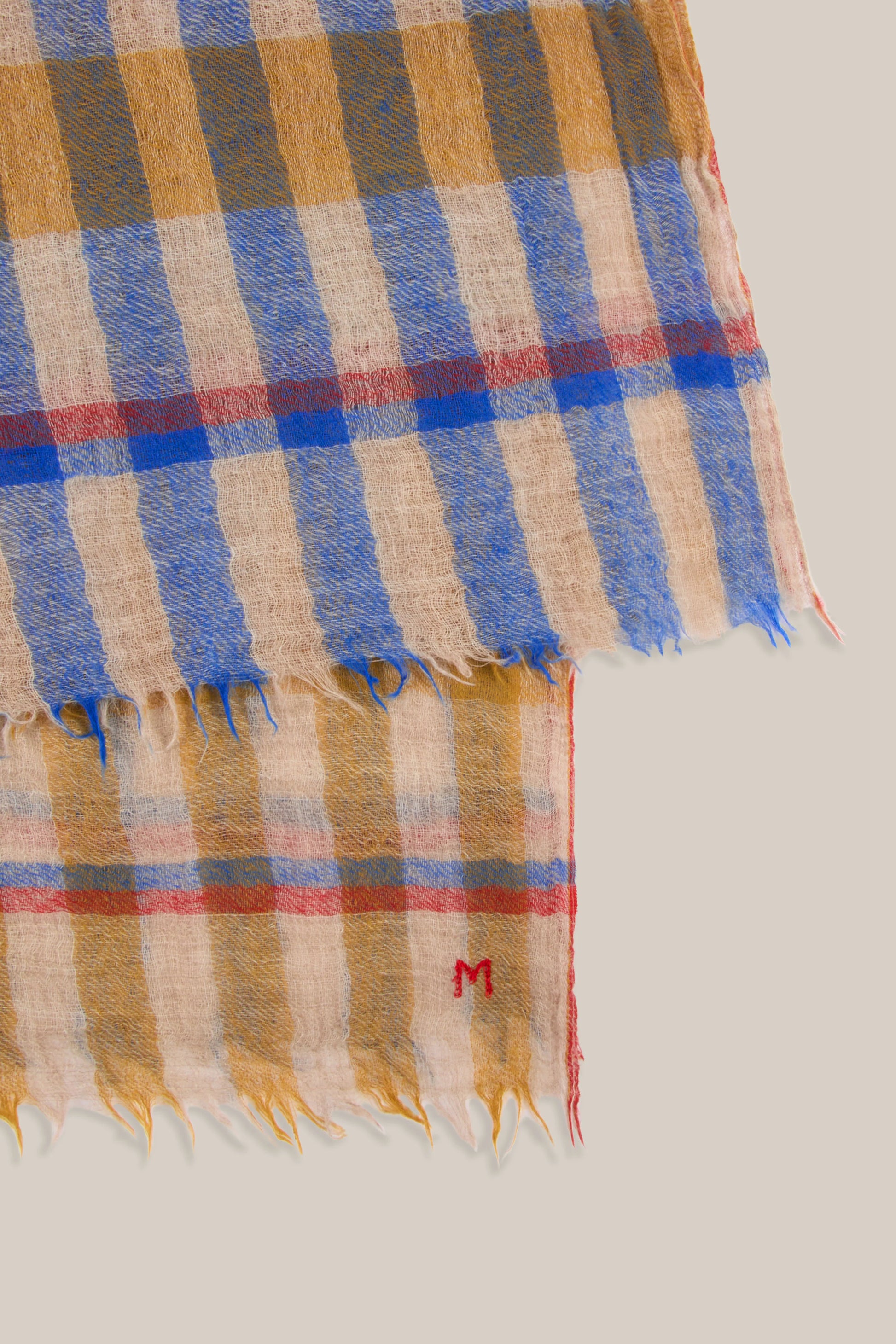 Moismont fine wool plaid tartan check scarf Acrobat in Celtic red, orange, mustard yellow, blue, tan and white.
