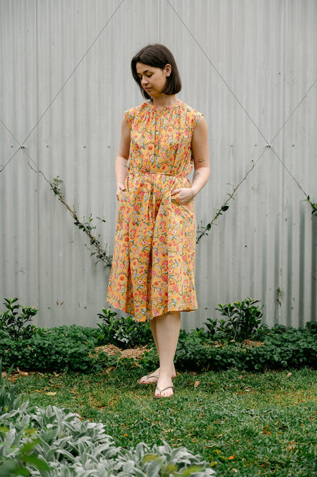 Juniper Hearth Zoe blockprint floral sleeveless cotton dress, buttonup with waist tie, in mustard yellow.