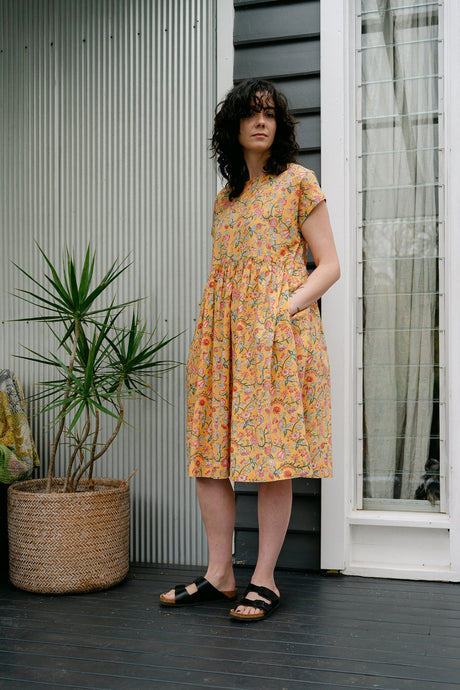 Juniper Hearth blockprint cotton dress with gathered skirt and pockets, in mustard floral.