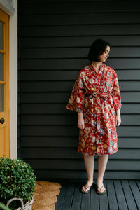 Juniper Hearth kimono in Malabar rust gold and cream and denim blue flowers on rust red background.