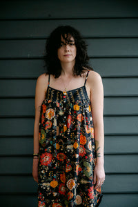 Juniper Hearth cotton voile nightdress in a vibrant all over tropical floral in coral, ecru and olive green on a black background