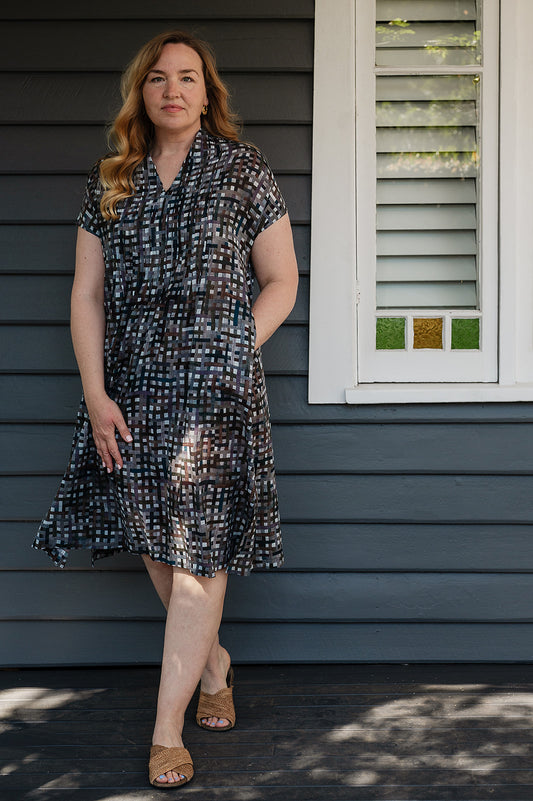 Neeru Kumar fine cotton pintucked  cap sleeved dress in charcoal and brown checks with teal highlights.