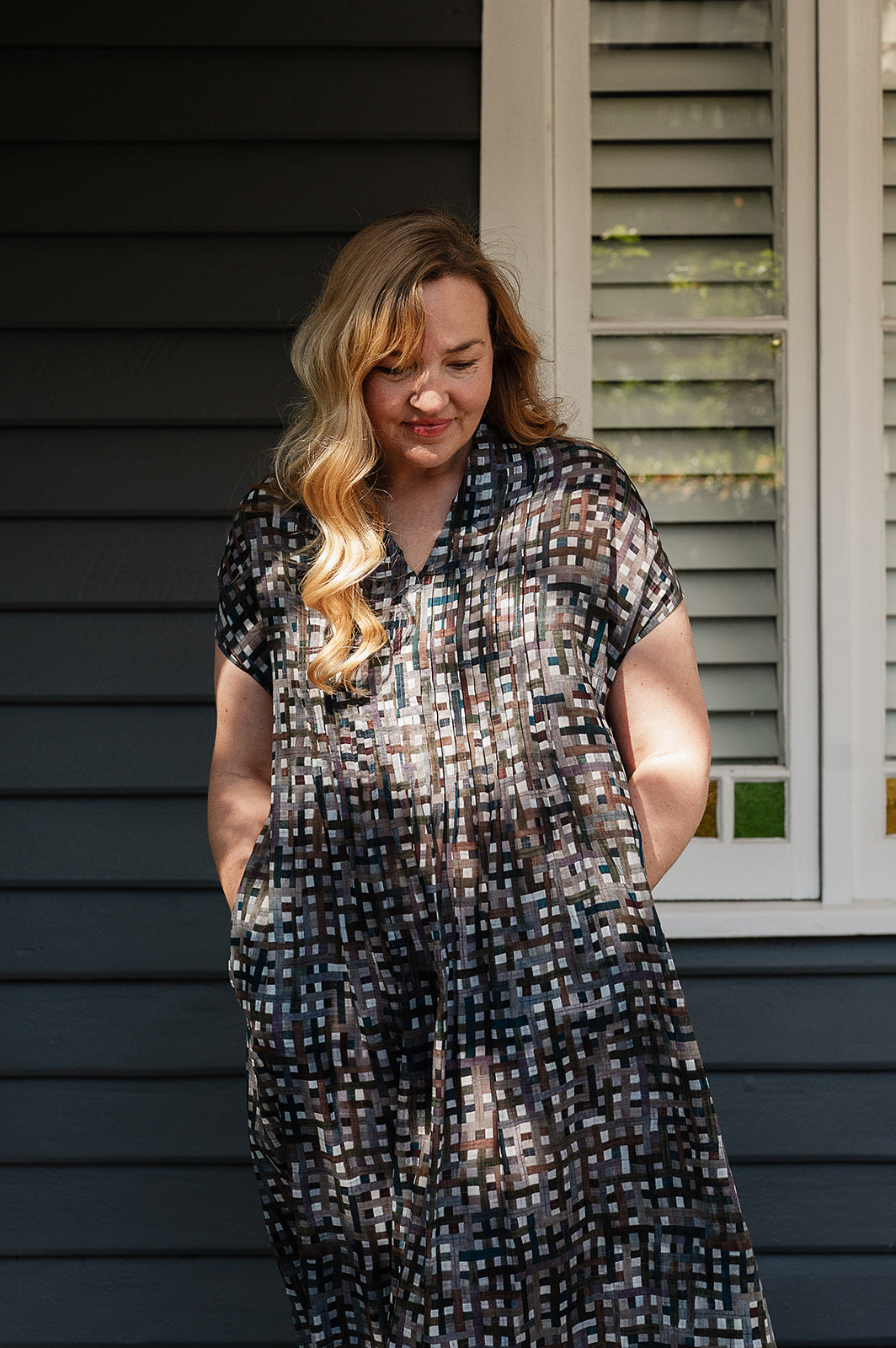 Neeru Kumar fine cotton pintucked  cap sleeved dress in charcoal and brown checks with teal highlights.