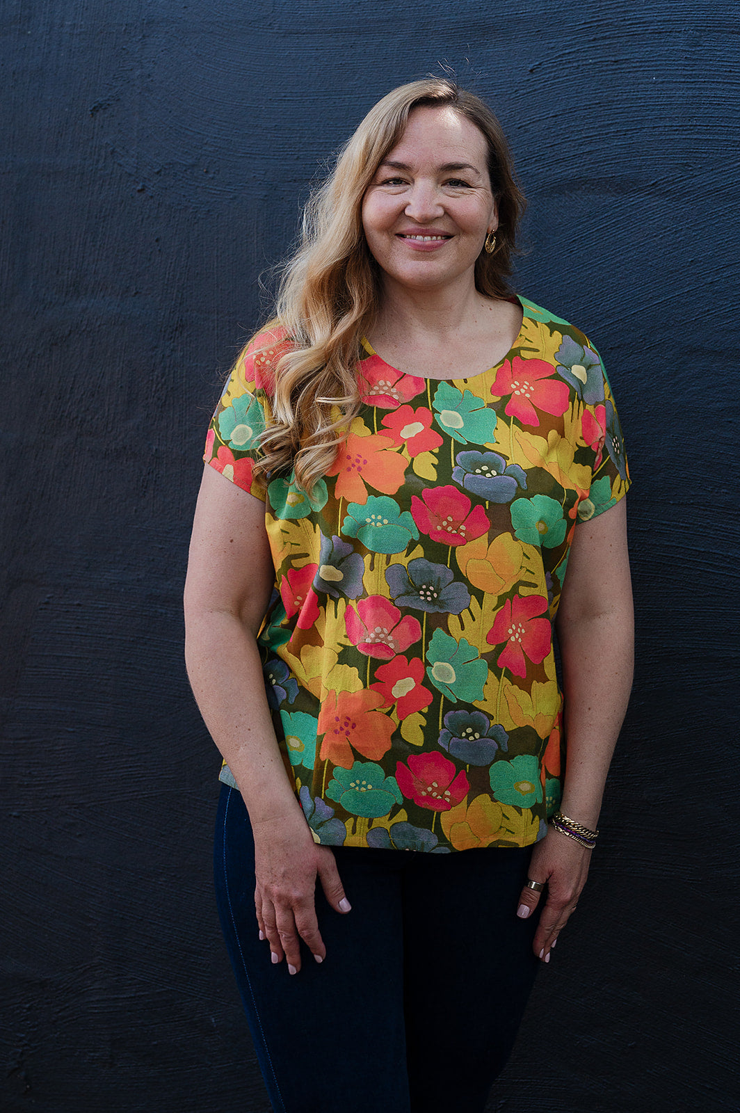 Neeru Kumar round neck cap sleeve top with a colorful floral pattern.