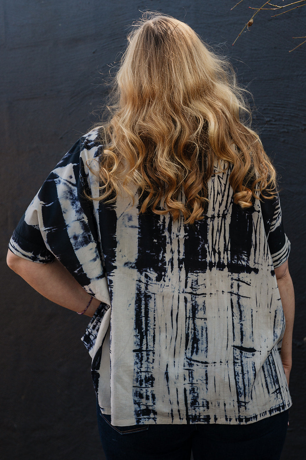 Neeru Kumar short-sleeve collared shirt with a black and white shibori tie-dye pattern.