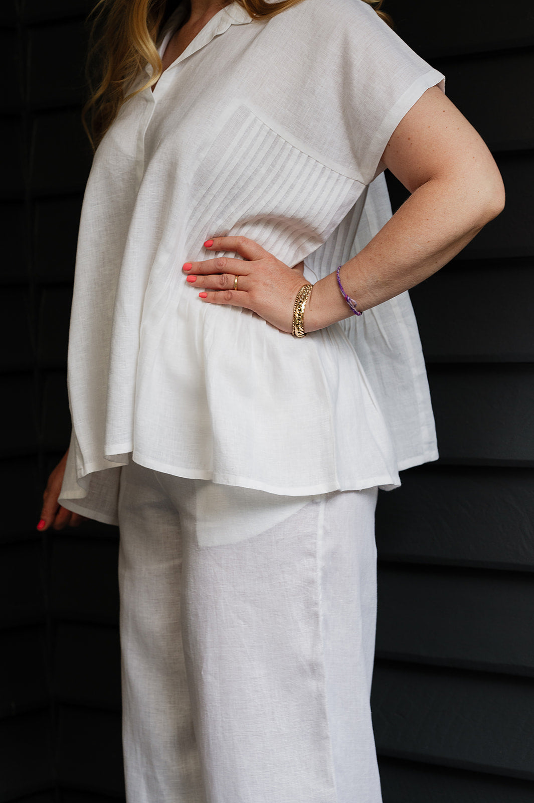 Manan Bonnie loose-fitting button up top with side pleat detailing in white linen.