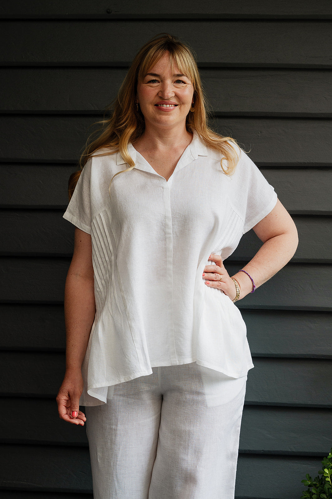 Manan Bonnie loose-fitting button up top with side pleat detailing in white linen.