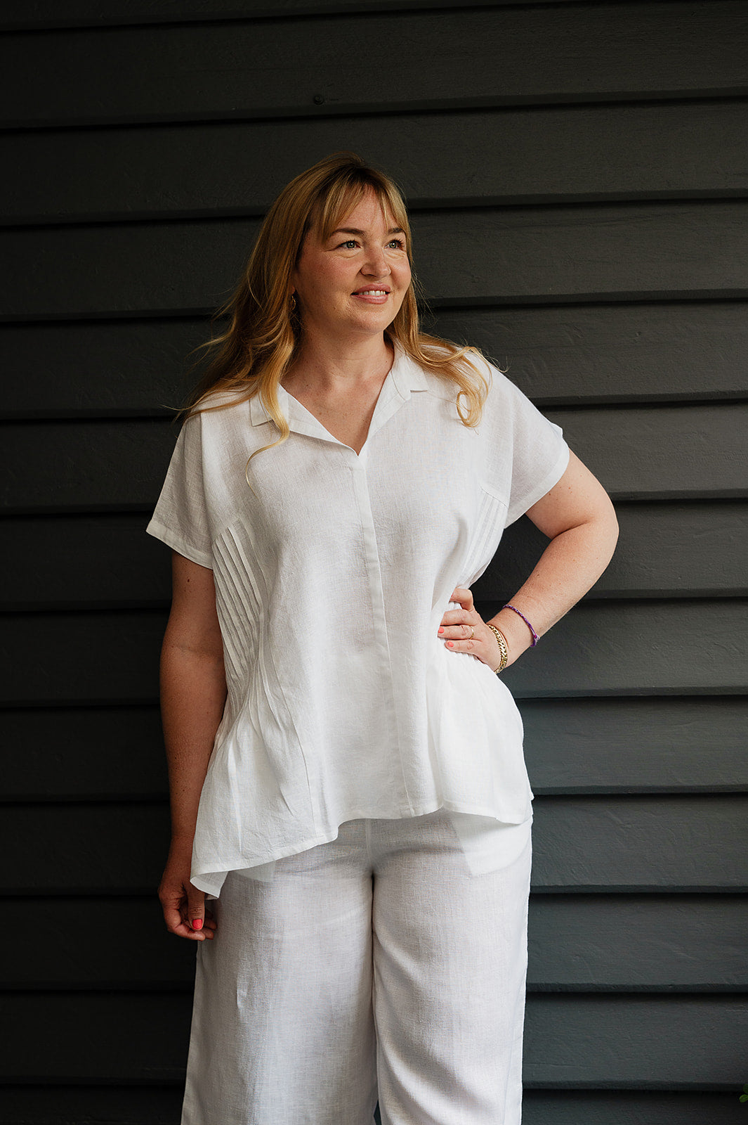 Manan Bonnie loose-fitting button up top with side pleat detailing in white linen.