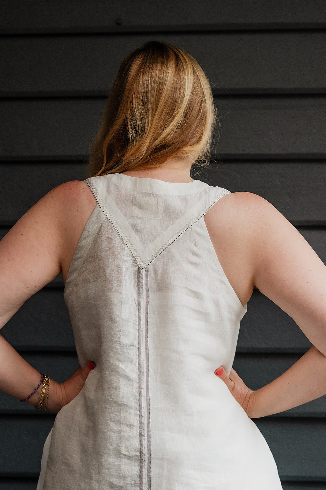 Manan Ayana V-neck sleeveless linen tunic dress with handwoven metallic border, stripe panels, selvedge detailing and hand-embroidery.