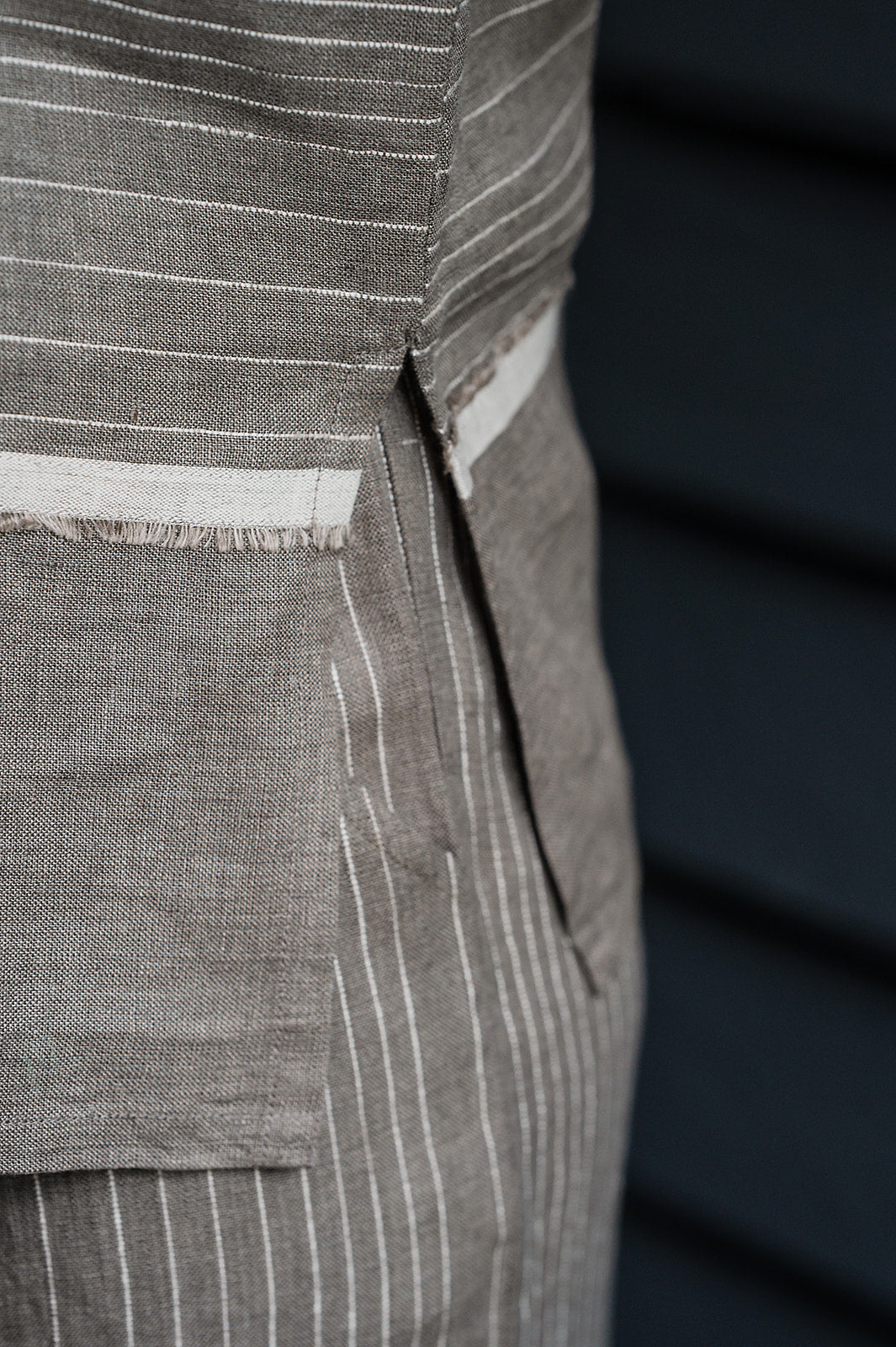 Manan Madhavi button up top in yarn-dyed grey and white stripe linen with panel detailing.