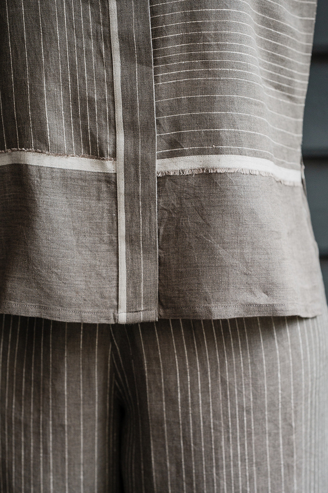 Manan Madhavi button up top in yarn-dyed grey and white stripe linen with panel detailing.