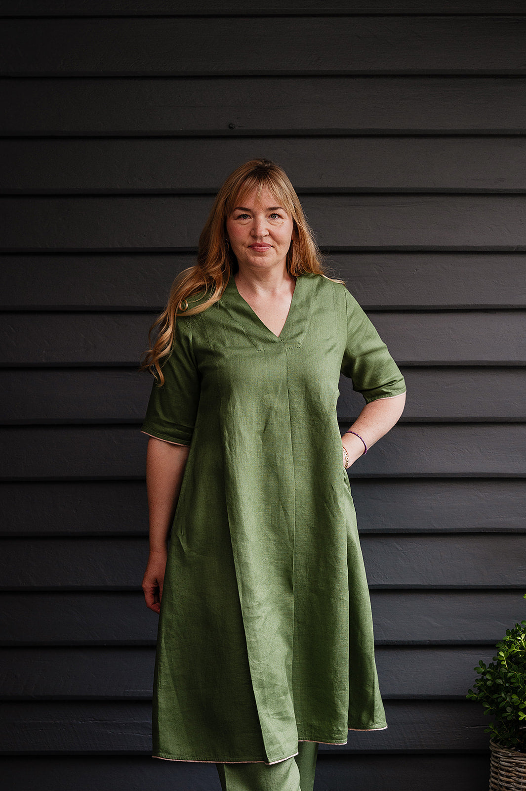 Manan Maki pleated linen short sleeve dress with V-neck in green.