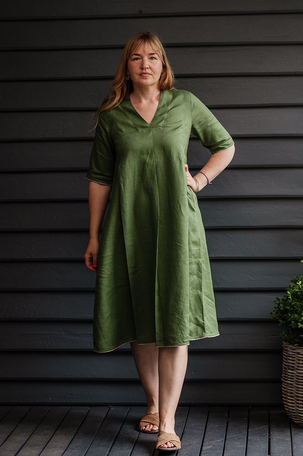 Manan Maki pleated linen short sleeve dress with V-neck in green.
