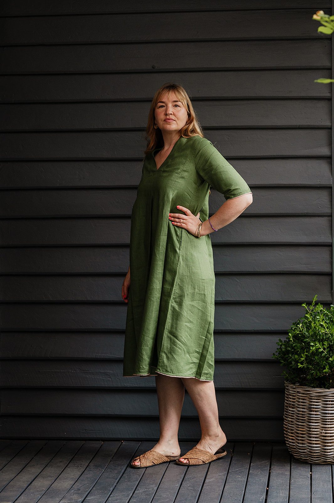 Manan Maki pleated linen short sleeve dress with V-neck in green.