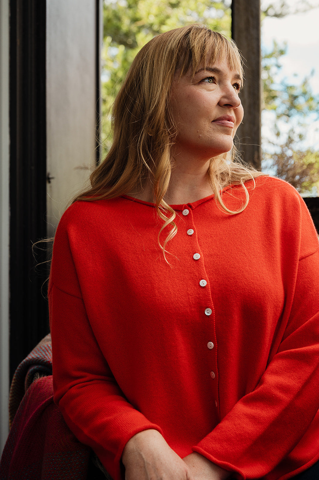 One size reversible cashmere cardigan in tangerine red orange.