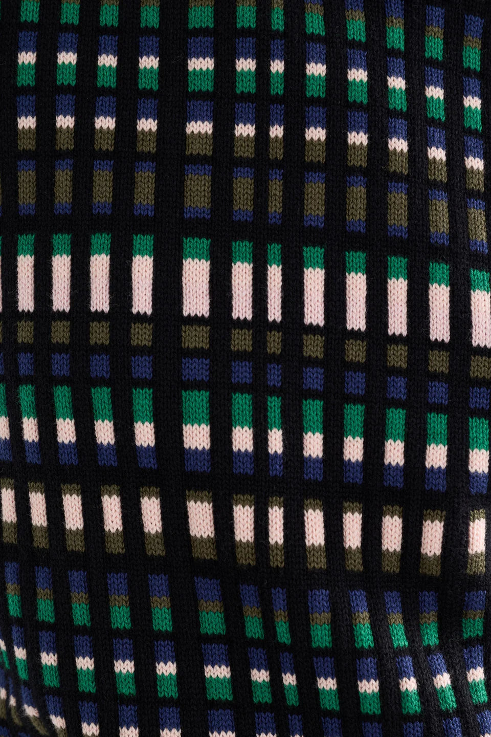 Close-up of a patterned fabric with green, blue, and white colors.